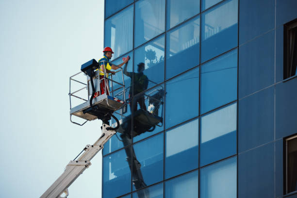 A worker cleaning the windows on a residential building