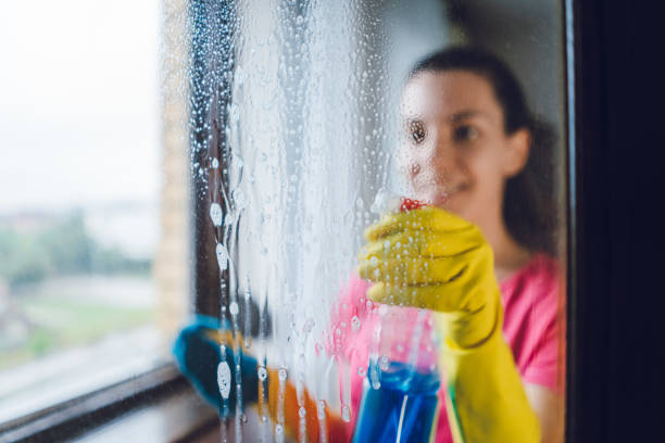 A woman cleaning a window